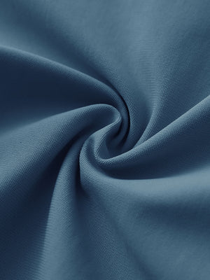 Close-up of grayish blue stretch plain everyday pants fabric showing smooth texture and flexible weave.