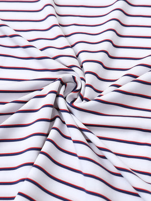 Close-up fabric view of youth performance golf polos, smooth texture with breathable white/navy stripe finish