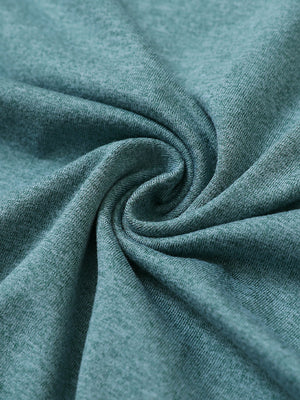 Close-up fabric detail of skin-friendly long sleeve melange polo, soft blend texture with aqua heather tone