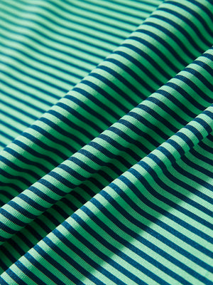 Texture close-up of Kids stripe golf polos with soft fabric and bright green stripe stripes