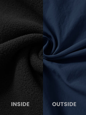 Close-up of the inside-out fabric of the reversible fleece jacket with 5 pockets in black.