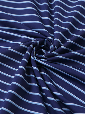 Close-up of dark blue/light blue popular yarn dyed stripe polo fabric showing crisp lines and soft texture.
