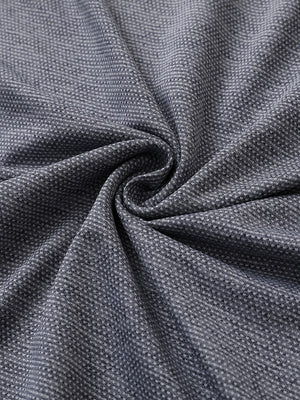 Close-up of navy heather ventilated heather jacquard polo fabric showing breathable texture and subtle pattern details.