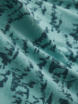 Fabric detail of Popular heather print polo with soft blended texture in cyan massif