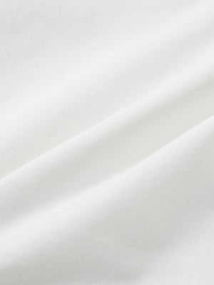 Close-up texture of white stretch cotton blend slim fit golf trousers 5 pockets fabric showing detailed cotton blend weave.