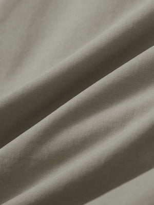 Close-up texture of khaki grey stretch cotton blend slim fit golf trousers 5 pockets fabric showing detailed cotton blend weave.
