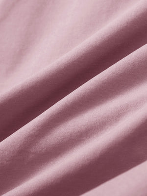 Close-up texture of pink stretch cotton blend slim fit golf trousers 5 pockets fabric showing detailed cotton blend weave.