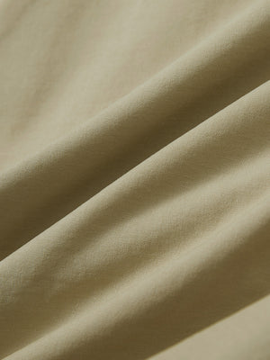 Close-up texture of khaki stretch cotton blend slim fit golf trousers 5 pockets fabric showing detailed cotton blend weave.
