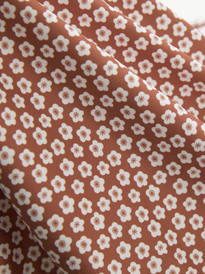 Close-up of brick white flower performance quick dry print golf polos fabric texture