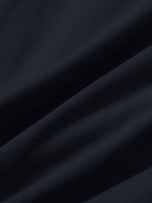 Close-up texture of navy stretch cotton blend slim fit golf trousers 5 pockets fabric showing detailed cotton blend weave.