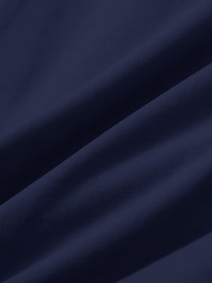 Close-up texture of dark blue stretch cotton blend slim fit golf trousers 5 pockets fabric showing detailed cotton blend weave.