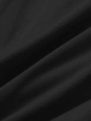 Close-up texture of black stretch cotton blend slim fit golf trousers 5 pockets fabric showing detailed cotton blend weave.