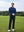 Model in navy long sleeve solid jersey polo holding a golf club outdoors, full-body shot