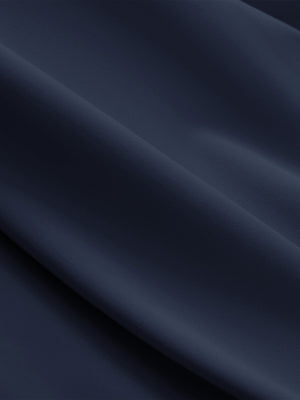 Close-up texture of navy breathable casual slacks with 4 pockets fabric showing detailed breathable material and weave.