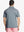 Back half-body shot of model wearing SLATE GREEN HEATHER Ventilated Heather Jacquard Polo