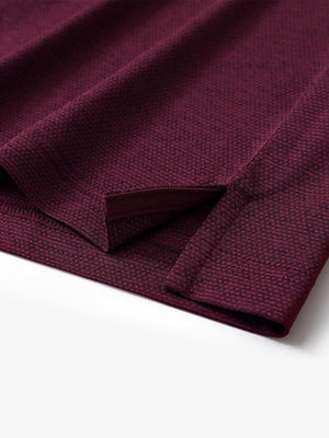 Close-up of side hem slit on Ventilated Heather Jacquard Polo in BURGUNDY HEATHER, showing detail