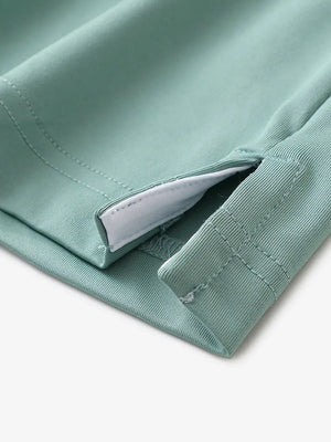 Close-up of hem slit detail in BERYL GREEN Premium Performance Polo