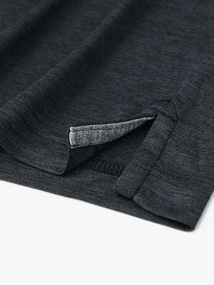 Close-up of hem opening on Modern Fit Melange Polo in BLACK HEATHER, showcasing fine stitching and design.
