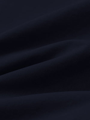 Macro view of the navy youth water resistant cotton blend golf pants fabric, showcasing the water repellent surface