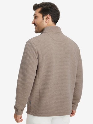 Back upper body view of model wearing textured insulated winter jacket, smooth finish, light brown heather.