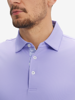 Close-up of a model wearing the lilac everyday classic solid polo, focusing on the collar and chest area