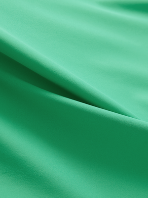 Close-up of the smooth cotton-blend fabric on the irland green everyday classic solid polo