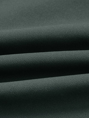 Fabric close-up of lightweight moisture wicking dress pants, showing texture and finish in dark dusty blue.