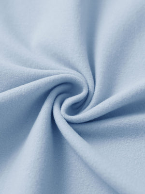 Fabric close-up of light grayish blue women's water-resistant stretch fleece lined jacket, soft stretch fabric with fleece lining.